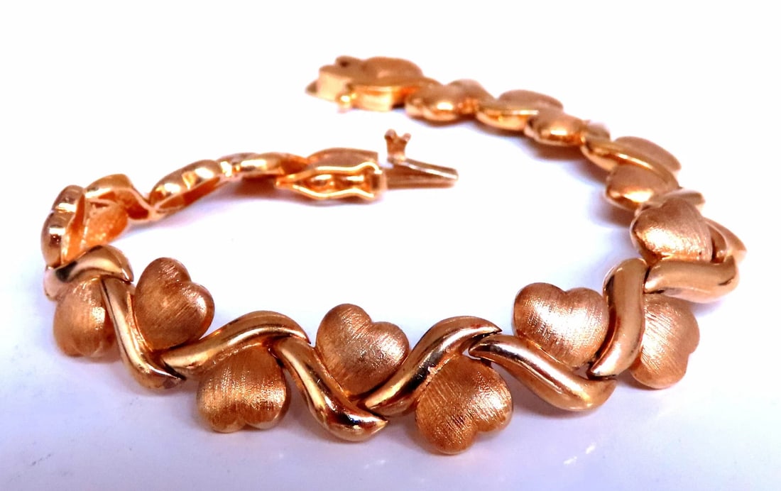 Sterling Silver Gold Plated Hearts X Bracelet 12454: Title: Sterling Silver Gold Plated Hearts X Bracelet 12454 $140.00 PRODUCT DESCRIPTION Hearts Satin Brush Silver bracelet. Plated with 14kt gold. 10mm wide 16 grams 7 inch
