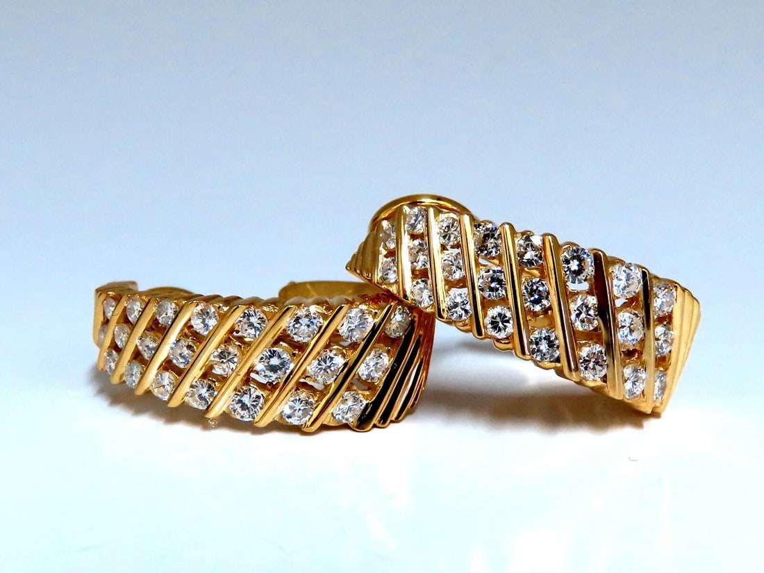 1.10ct Natural Diamonds Slant Row Channel Semi Hoop Earrings 14kt: Magnificent Jewels Stripped Semi Hoop Diamond earrings. 1.10ct. Natural diamonds Rounds, full cut. G colors Vs-2 clarity. 14kt. yellow gold. Comfortable clips. 12 Grams. 25mm Long 9mm wide $6000