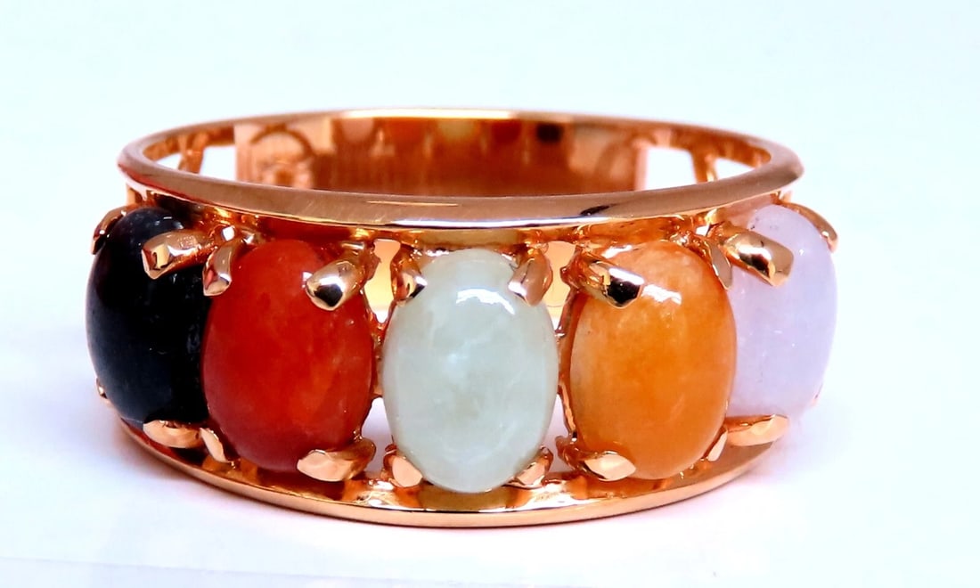 Cabochon Variety Jade Ring 14kt Gold: 5 Jade Band Average each: 7x4mm Multicolors 14kt. yellow gold 4.6 grams. Ring measures: 9mm wide Depth: 3mm current ring size: 9.5 All Items come with a Free White ribbon gift box. Reserve: $736.