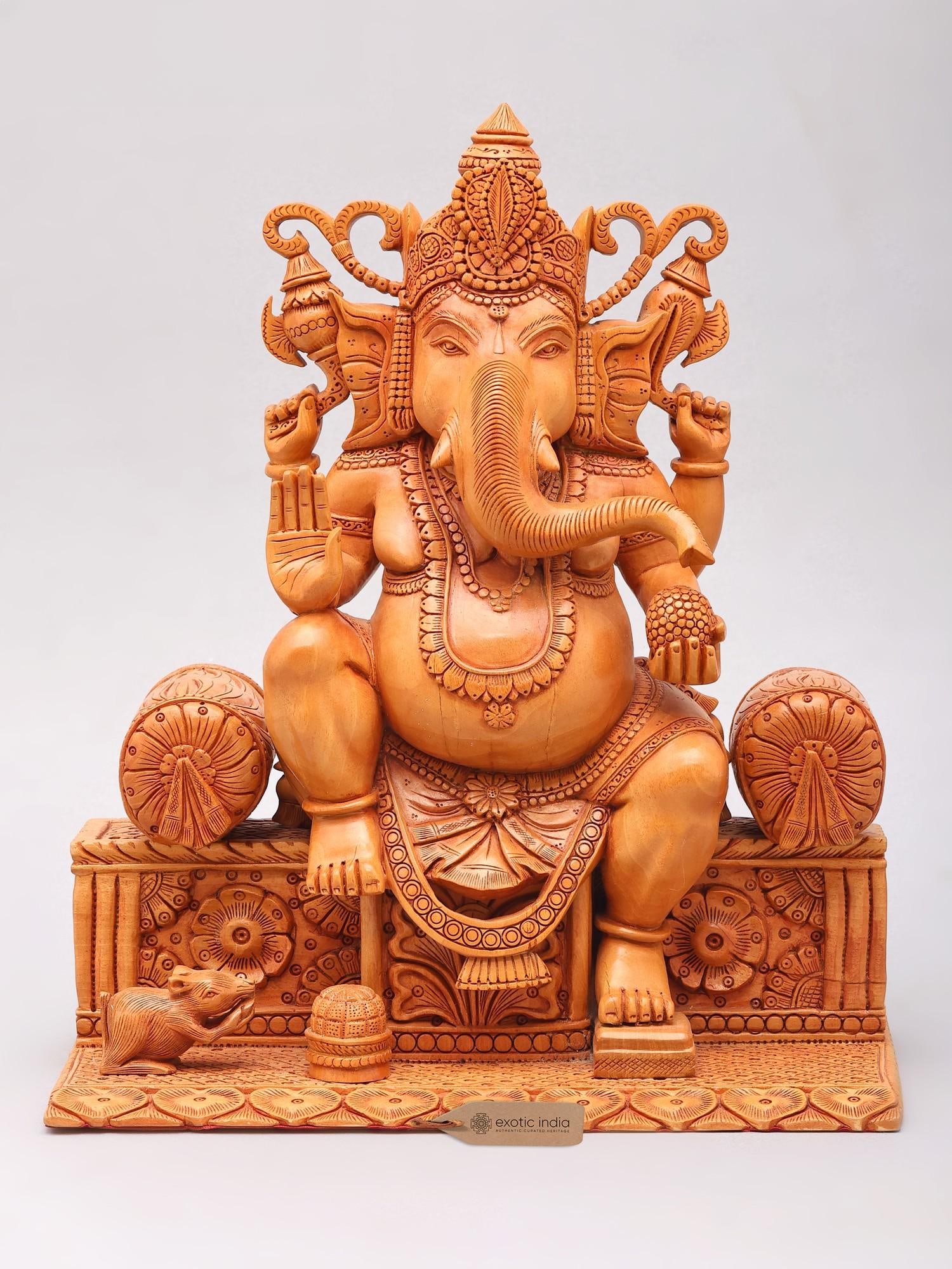 12" Four Armed Blessing Lord Ganesha Seated on Singhasan | Wood Carved Statue: Description: 12" Four Armed Blessing Lord Ganesha Seated on Singhasan | Wood Carved Statue