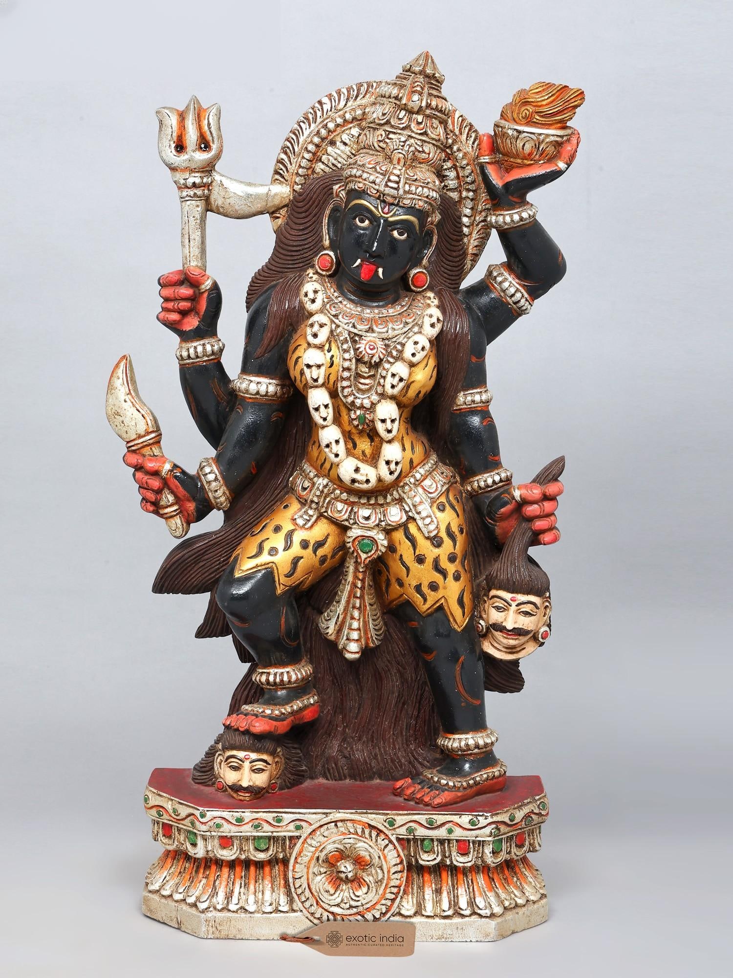 Goddess Kali in Triumph | Large Hand-Painted Statue | Wood Carving: Description: This wooden sculpture of Goddess Kali unfolds with theatrical intensity, where colour, carving, and iconography evoke her as the fierce yet protective Mother. The deep black of her body