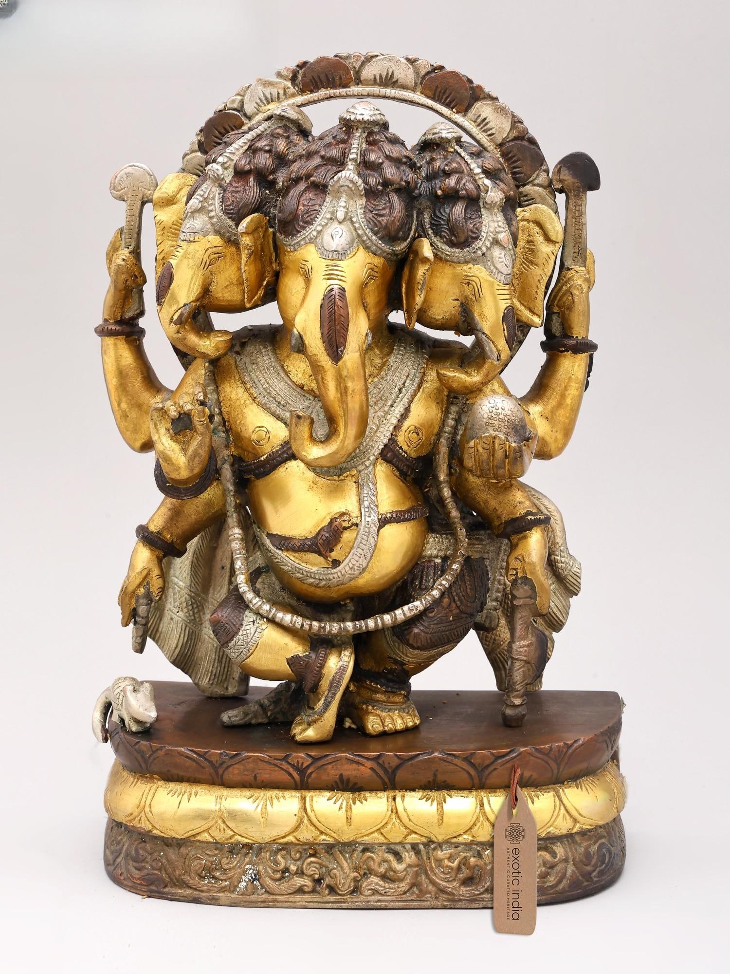 12" Three Headed Dancing Ganesha Brass Idol | Handmade Brass Statue: Description: Endowed with child-like innocence, mischief in eyes and carefree disposition, the cool, soft and benign elephant-headed Ganesha is invoked primarily for removing obstacles and assuring a