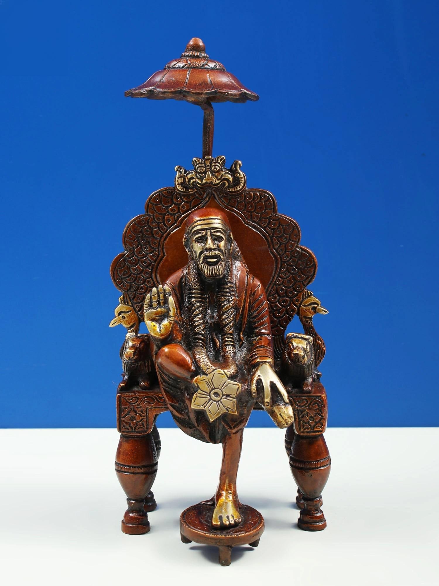 7" Handmade Sai Baba Brass Idol Seated on Throne | Authentic Made in India | Spiritual Decor: Description: See It In Your Home Craft and art reaches the next level with this amazing statue, which exactly pictures the Sai Baba, his face sculpted with the iconic beard. The great Faqir is embelli