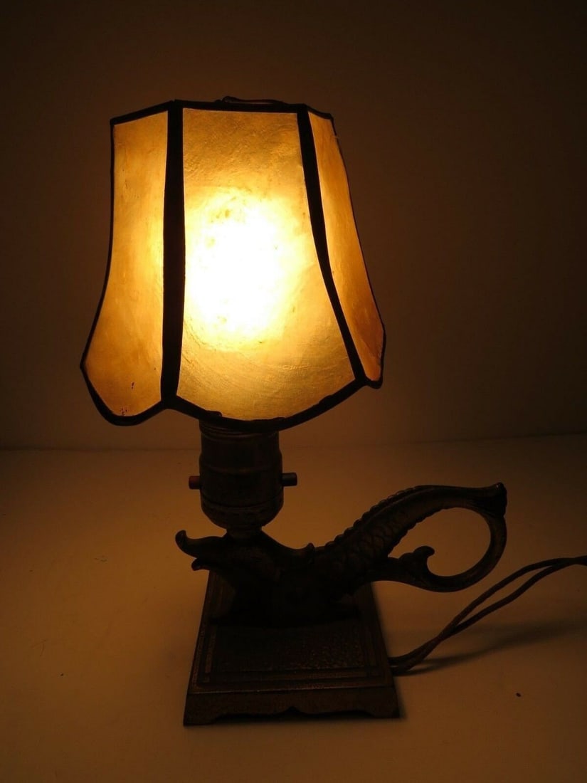 Chinoiserie Brass Sea Serpent Lamp Capiz Shell Shade Arts & Crafts Mini Fish Desk Light: Bring a touch of mystical maritime history to your home with this rare, vintage Asian-inspired "Sea Serpent" petite table lamp. Crafted in the Arts and Crafts style, this unique piece features a heavy