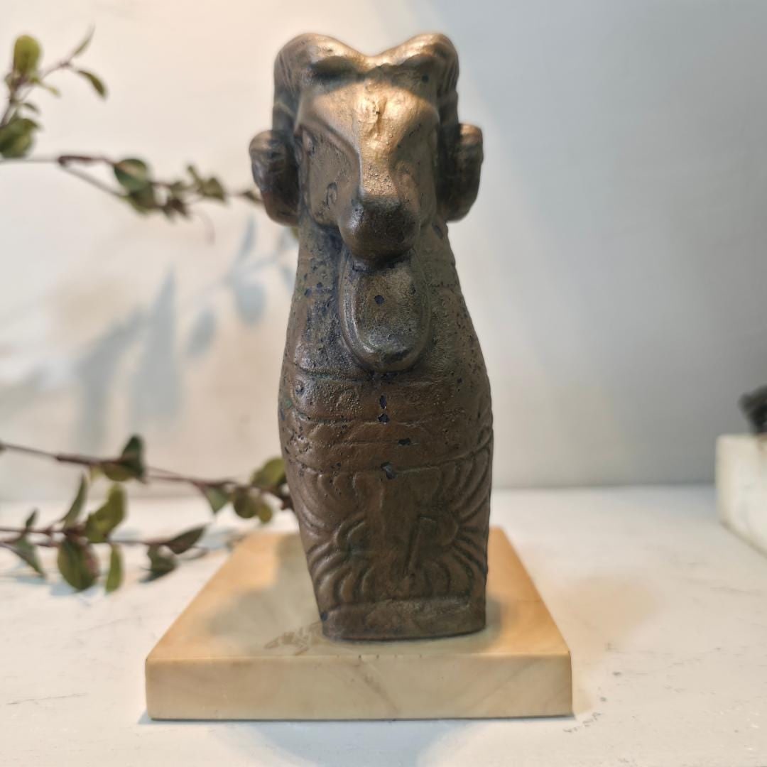 Vintage Mid Century Ram Sculpture Bronze Finish Ceramic Animal Figurine: A sculptural vintage ram figurine with bold mid-century character. This decorative animal sculpture features a stylized ram form with an aged bronze-toned finish, mounted on a solid stone or faux-marb