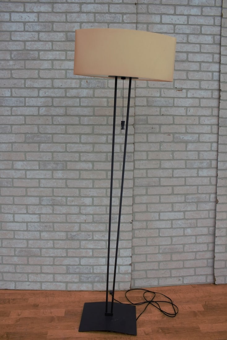 Mid Century Modern Black Iron Floor Lamp with Shade: Mid Century Modern Iron Floor Lamp with Shade This sophisticated matte black iron floor lamp features two slender matte black iron columns supported by a rectangular foot base. A cream fabric cylinder