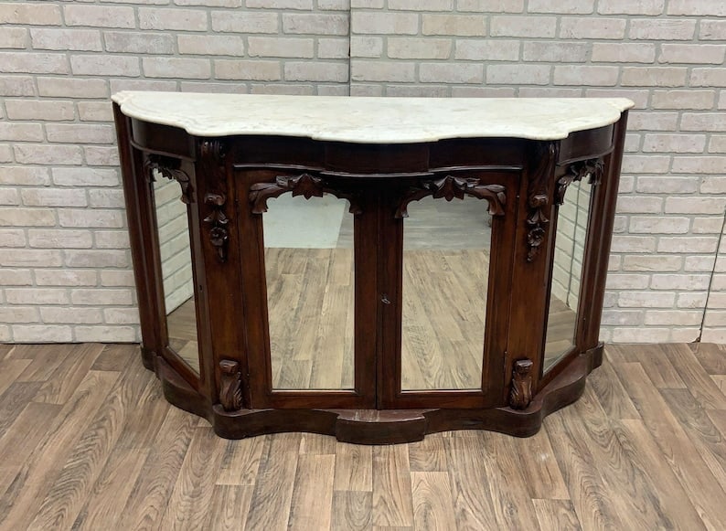 Antique American Empire Rosewood Sideboard Cabinet: Antique American Empire Rosewood and Marble Top Sideboard Cabinet This exquisite antique American Empire sideboard cabinet features stunning hand-carved rosewood details and a serpentine design that