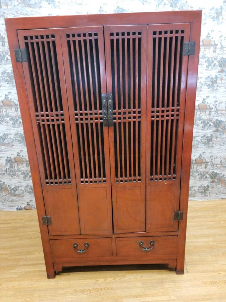 Antique Shanxi Province Red Lacquered Elm Storage Cabinet: Antique Shanxi Province Red Lacquered Elmwood Storage Cabinet This antique cabinet features gorgeous doors with finely detailed lattice patterns. The doors open up to three spacious display shelf and 