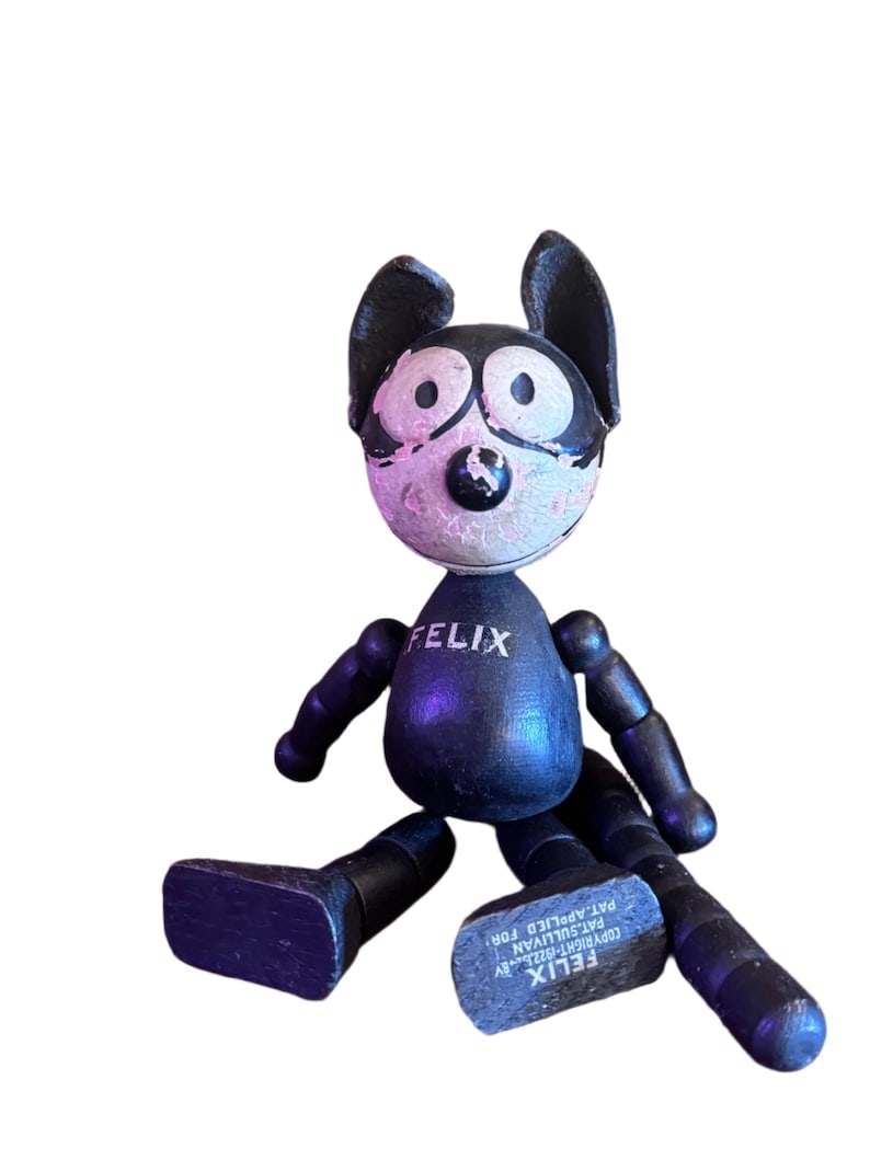 Antique Felix The Cat Wooden and Leather Toy: 1920’s Felix The Cat Wood and Leather Toy This 1920s Felix the Cat toy is a collectible vintage toy featuring the iconic character Felix the Cat. These toys are highly sought after by collectors