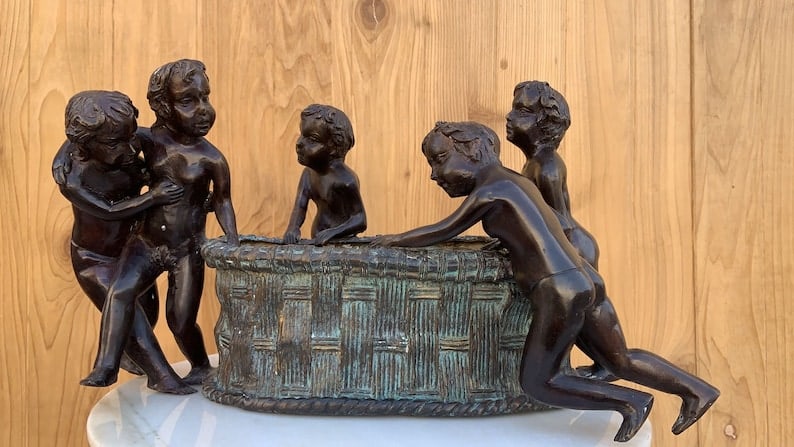 Vintage Figural Bronze Planter by Maitland Smith: Maitland Smith Bronze Planter with Five Boys A Maitland Smith bronze planter featuring five boys is a distinctive and artistic piece of home decor. This planter is likely crafted from bronze, a durabl
