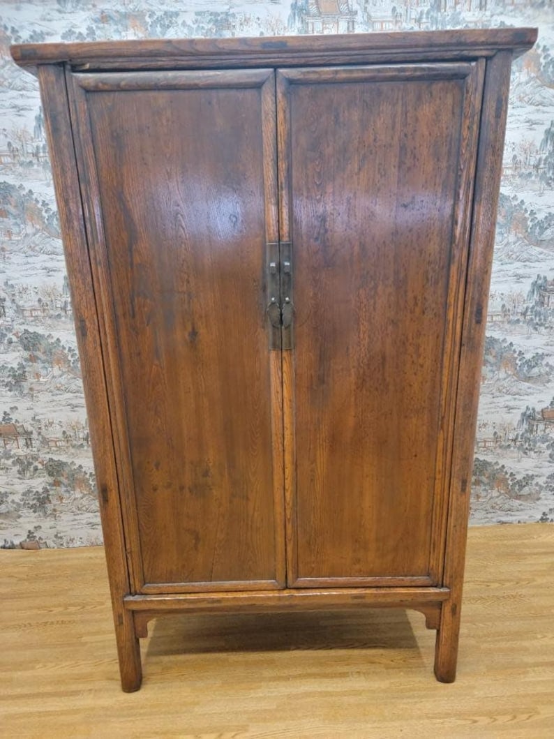 Antique Shanxi Province Elm Armoire Storage Closet: Antique Shanxi Province Elm 2 Door Cabinet This early 20th-century elm cabinet from China’s Shanxi Province showcases a beautiful balance of minimalist form and rustic character. The design feat