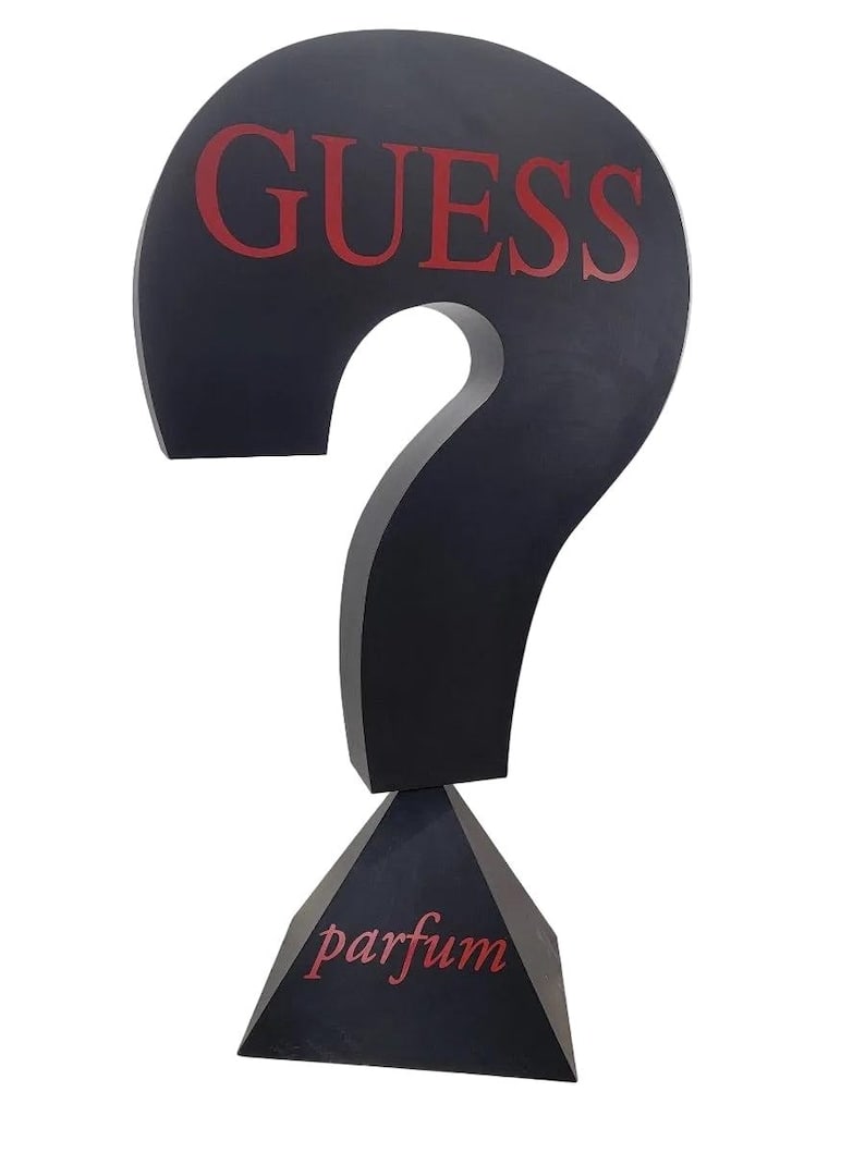 Vintage 7.5 Foot Black Wood Guess Cultural Advertising Sign: Vintage 7.5 Foot Black Wood Guess Cultural Advertising SignVintage 7.5 foot wood black "Guess Parfum" signature question mark advertising sign. This sign would be perfect for a fashion boutique or