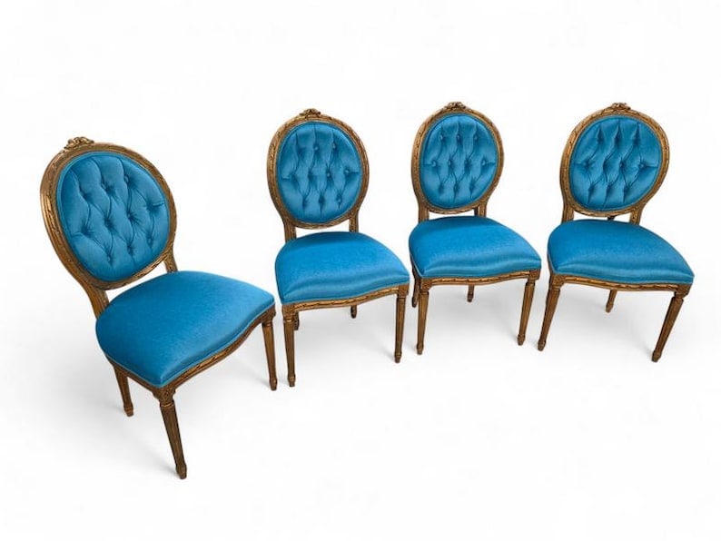 Antique French Carved Chairs Newly Reupholstered - Set of 4: Antique French Louis XVI Style Carved & Gilded Tufted Medallion Back Dining Chairs Newly Reupholstered in a Italian Royal-Teal Mohair - Set of 4 Bring refined elegance to your dining space with this s