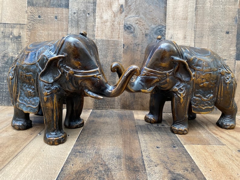 Antique Ornate Bronze Elephants - Pair: Antique Ornate Bronze Elephants - Pair Decorate your mantlepiece or side/coffee tables with these bronze elephant sculptures. The elephants are adorned with saddles and head gear. These are perfect fo