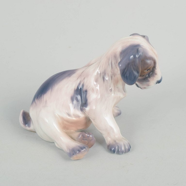 Dahl Jensen, Denmark. Porcelain dog figurine in muted tones with brown-grey accents. Approx. 1930s. - 2