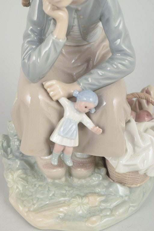 Lladró,, Spain. Porcelain figurine of a seated girl with doll in pastel tones. Approx. 1980s. - 3