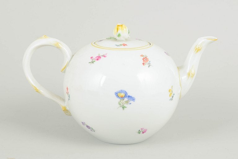 Meissen, Germany. Porcelain teapot with polychrome flower decoration. Mid-20th century.: Meissen, teapot with polychrome flower decoration. Porcelain teapot hand painted with polychrome flowers and decorated with a gilt rim. Rounded body with curved spout and elegant handle, complete with