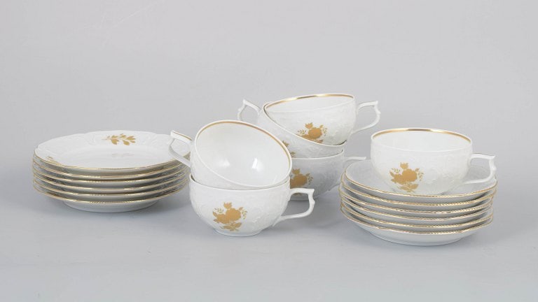 Rosenthal, Germany. Classic Rose set of six porcelain teacups with matching saucers and six cake: Rosenthal Classic Rose set of six teacups with matching saucers and six cake plates. Elegant porcelain service in white porcelain with relief decoration, gilded rose motifs, and gold trim. Comprising 