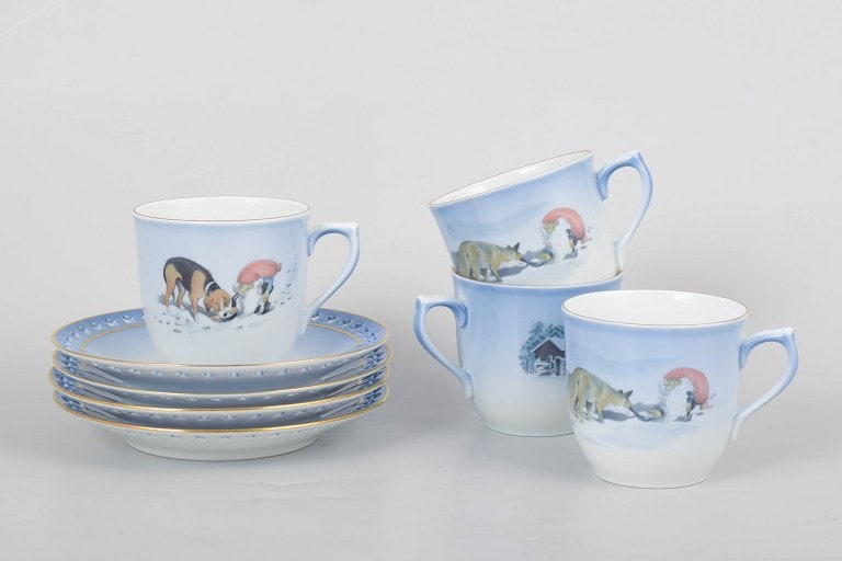 Harald Wiberg for Bing & Grøndahll, Denmark. Set of four porcelain coffee cups with matching: Harald Wiberg for Bing & Grøndahll, set of four coffee cups with matching saucers. Decorated porcelain with winter and gnome motifs in soft blue tones. The coffee cups measure 7 x 9 cm, and the s