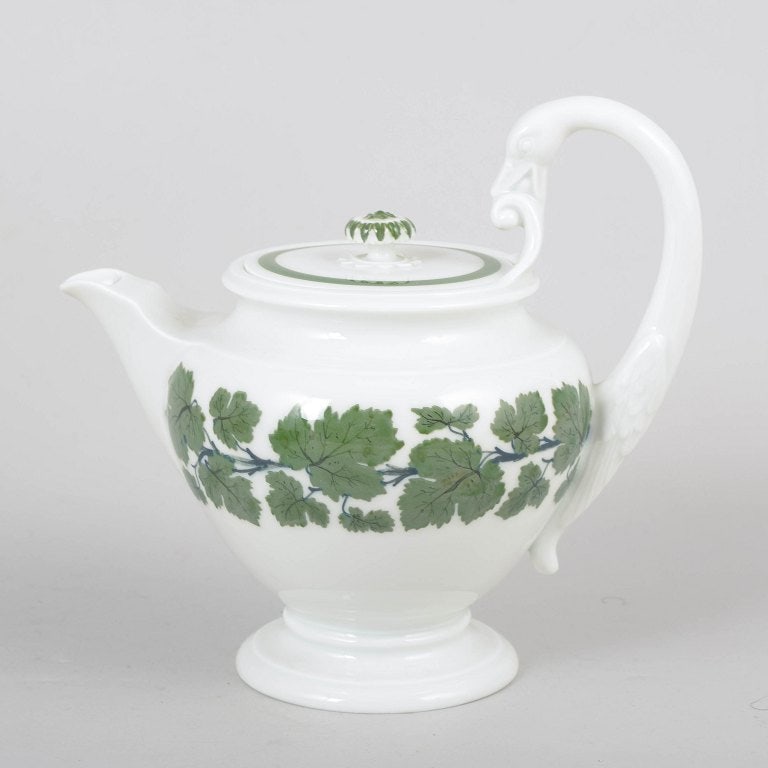 Meissen, Germany. Porcelain vine leaf teapot with sculptural knop, and shaped handle. Circa 1900.: Meissen vine leaf teapot. Elegant porcelain teapot with hand-painted vine leaf decoration, sculptural knop, and distinctive shaped handle in classic Meissen style. Marked with Meissen crossed swords a