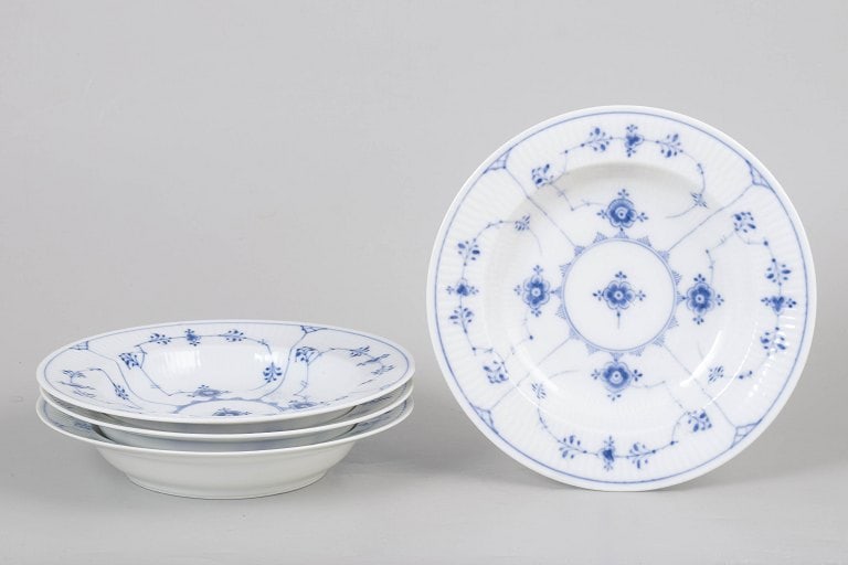 Royal Copenhagen, Denmark. Blue Fluted Plain set of four porcelain deep plates. Approx. 1920s.: Royal Copenhagen Blue Fluted Plain, set of four deep plates. Classic hand-painted deep porcelain plates in the Blue Fluted Plain pattern, model 1/170, factory canceled with one incised sorting line. O