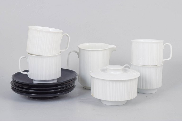 Tapio Wirkkala for Rosenthal Studio-Line, Germany. Set of four porcelain coffee cups with saucers,: Tapio Wirkkala for Rosenthal Studio-Line, set of four coffee cups with saucers, sugar bowl and creamer. Elegant porcelain set consisting of four coffee cups with saucers, sugar bowl, and creamer with 