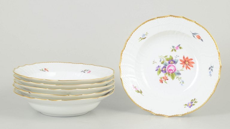 Royal Copenhagen, Denmark. Saxon flower, set of six porcelain deep plates with floral motifs.: Royal Copenhagen Saxon flower, set of six deep plates. Set of six deep porcelain plates decorated with hand-painted floral motifs in the Saxon flower pattern and finished with a gilded rim. Model 21/1