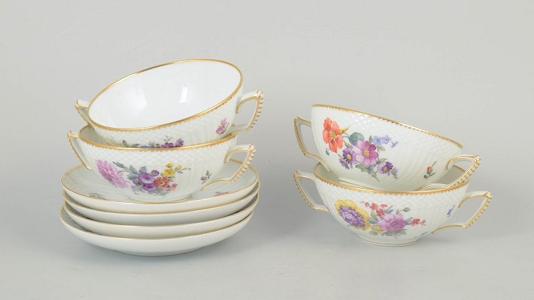 Royal Copenhagen, Denmark. Saxon flower, set of four porcelain bouillon cups with saucers floral: Royal Copenhagen Saxon flower, set of four bouillon cups with saucers. Set of four bouillon cups with matching saucers in porcelain decorated with hand-painted floral motifs in the Saxon flower patter
