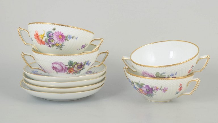 Royal Copenhagen, Denmark. Saxon flower, set of four porcelain bouillon cups with saucers with: Royal Copenhagen Saxon flower, set of four bouillon cups with saucers. Set of four bouillon cups with matching saucers in porcelain decorated with hand-painted floral motifs in the Saxon flower patter