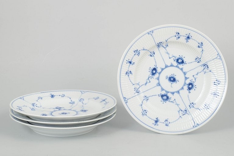 Royal Copenhagen, Denmark. Blue Fluted Plain, set of four porcelain dinner plates with cobalt blue: Royal Copenhagen Blue Fluted Plain, set of four dinner plates. Classic set of four dinner plates from Royal Copenhagen's Blue Fluted Plain service, model 1/175, crafted in hand-painted porcelain with 