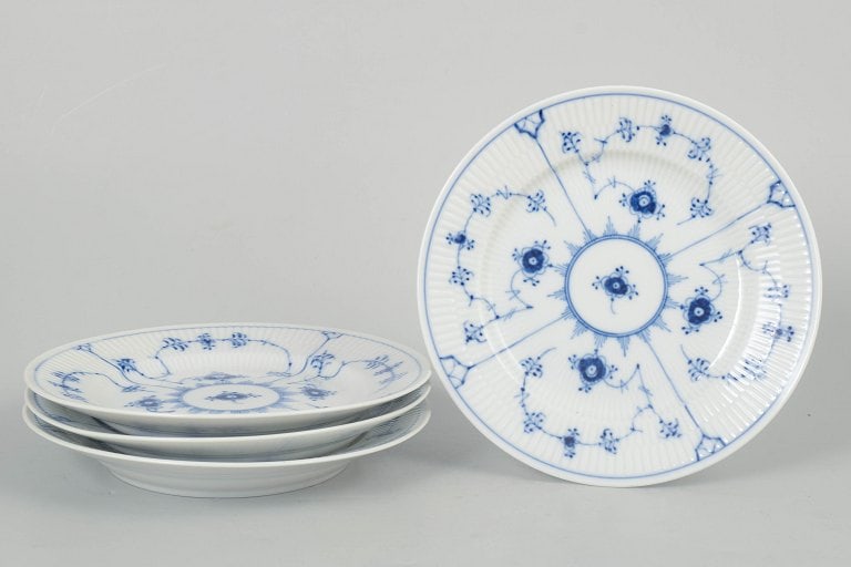Royal Copenhagen, Denmark. Blue Fluted Plain, set of four porcelain salad plates with cobalt blue: Royal Copenhagen Blue Fluted Plain, set of four salad plates. Classic set of four salad plates from Royal Copenhagen's Blue Fluted Plain service, model 1/179, crafted in hand-painted porcelain with th