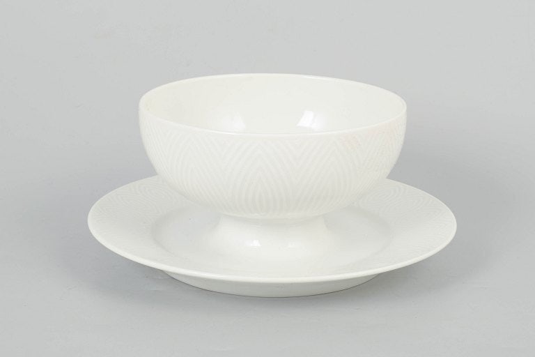 Axel Salto for Royal Copenhagen, Denmark. Porcelain sauce boat with relief decoration. Approx.: Axel Salto for Royal Copenhagen, sauce boat. Elegant porcelain sauce boat with refined relief decoration and harmonious organic form, produced for Royal Copenhagen. The form reflects Axel Salto's char