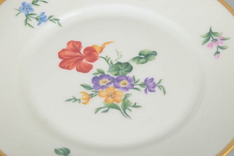 Rosenthal, Germany. Porcelain set of twelve plates with polychrome floral decoration and gilded rim. - 3