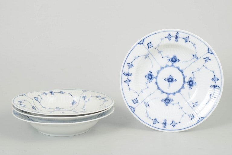 Royal Copenhagen, Denmark. Blue Fluted Plain, porcelain set of four pasta plates with cobalt blue: Royal Copenhagen Blue Fluted Plain, set of four pasta plates. Classic set of four pasta plates from Royal Copenhagen's Blue Fluted Plain service, model 1/168, crafted in hand-painted porcelain with th