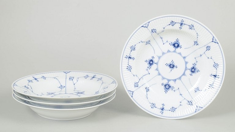 Royal Copenhagen, Denmark. Blue Fluted Plain, porcelain set of four deep plates with cobalt blue: Royal Copenhagen Blue Fluted Plain, set of four deep plates. Classic set of four deep plates from Royal Copenhagen's Blue Fluted Plain service, model 1/165, crafted in hand-painted porcelain with the 