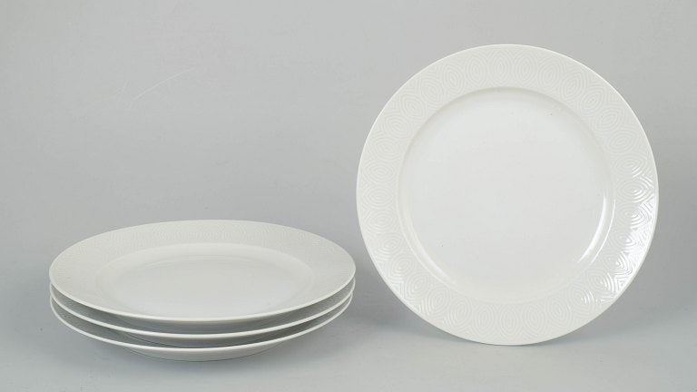 Axel Salto for Royal Copenhagen, Denmark. Porcelain set of four dinner plates with relief: Axel Salto for Royal Copenhagen, set of four dinner plates. Elegant set of four porcelain dinner plates with refined relief decoration and harmonious proportions, produced for Royal Copenhagen. The de