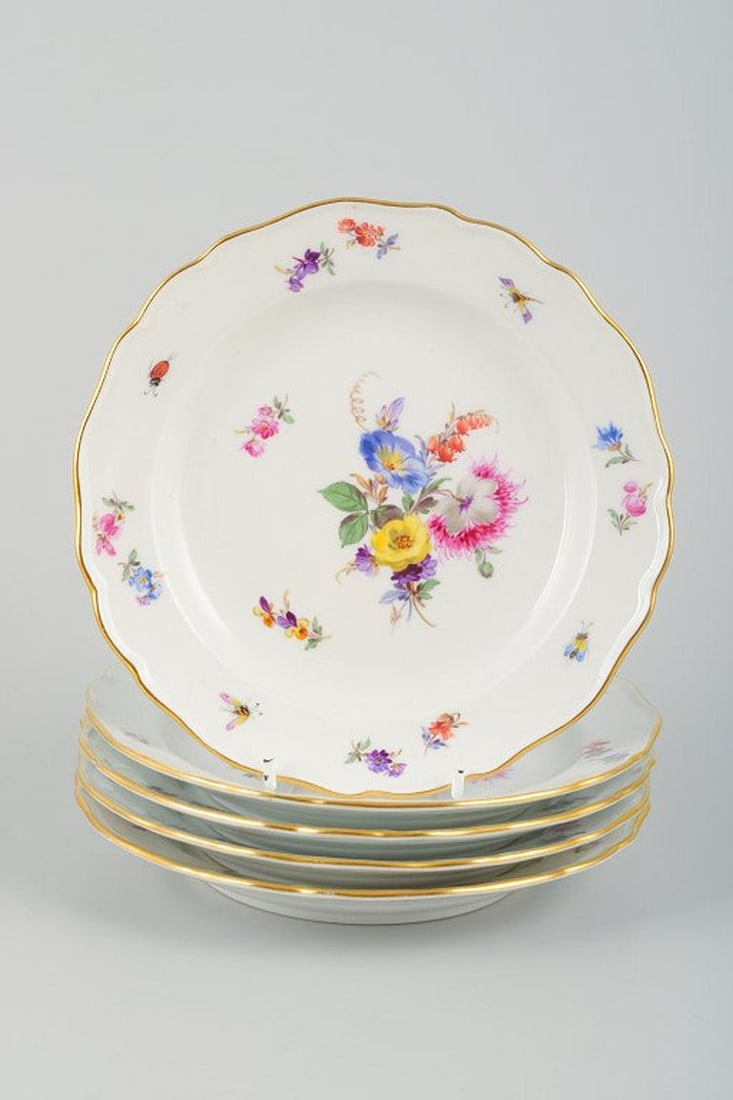 Meissen, Germany. A set of five porcelain plates. Hand-painted with various floral motifs. Mid-20th (1 of 4)