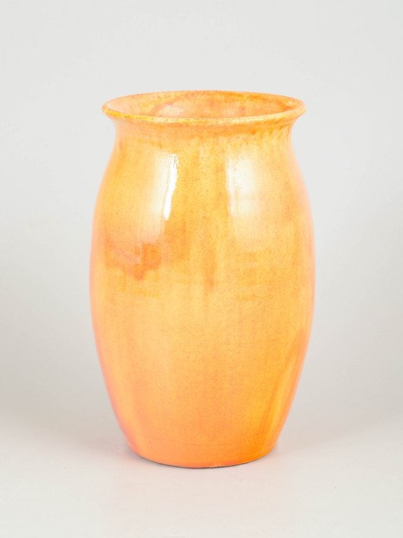 Kähler, Denmark. Yellow glazed vase in earthenware with tapering form. Approx. 1930s.: Kähler, yellow glazed vase. Elegant vase in glazed earthenware with a softly tapering form and slightly flared rim. Executed in a light yellow glaze with warm orange tones and fine vertical runs 