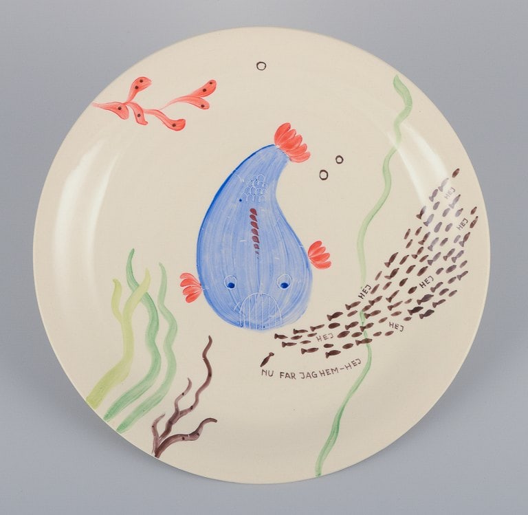 Stig Lindberg for Gustavsberg. "Löja" plate. Hand-painted with a fish motif. Satirical: Stig Lindberg for Gustavsberg. "Löja" plate. Hand-painted with a fish motif. Satirical illustration with Swedish text. From the 1950s. In perfect condition. Marked. Measures: 24.5 cm. Reserve: