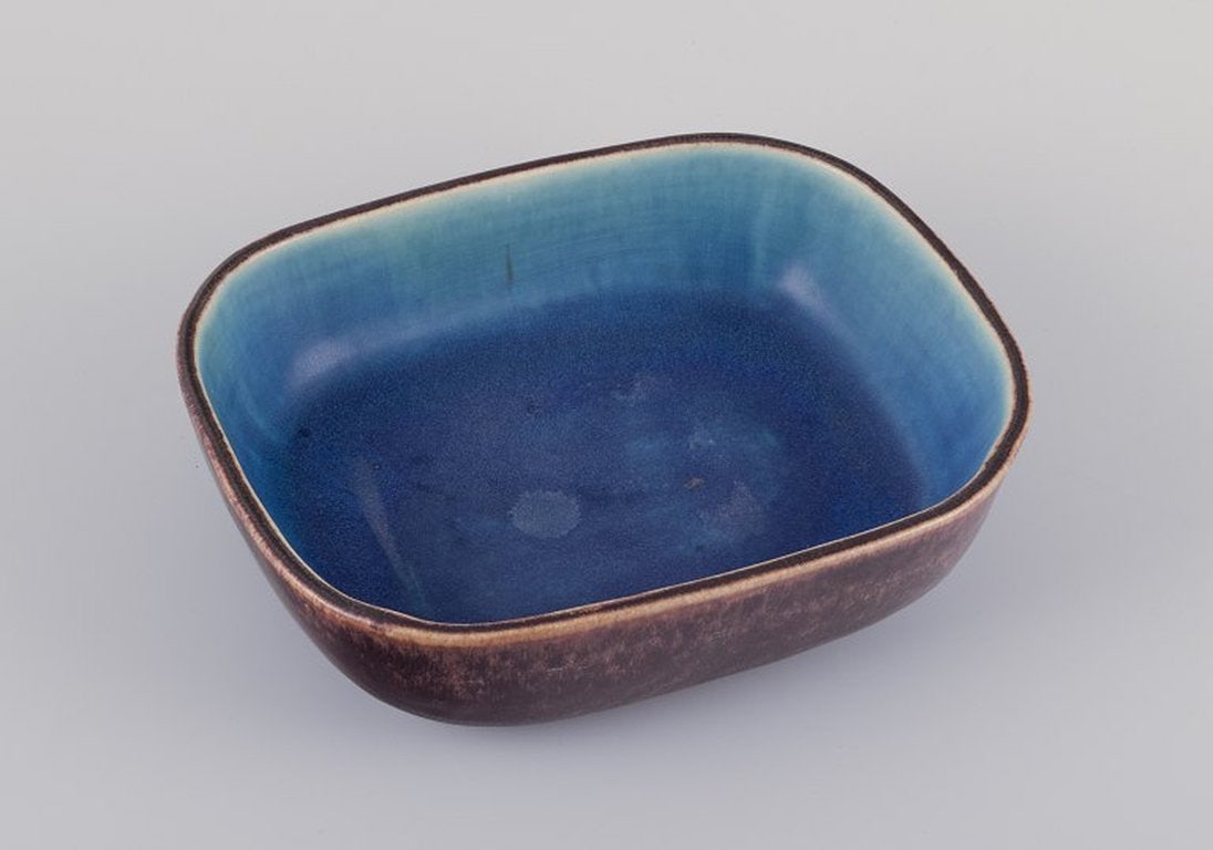 Eva StÃ¦hr-Nielsen for Saxbo, Denmark. Large rectangular ceramic bowl. Mid-20th century.: Eva StÃ¦hr-Nielsen (1911-1976) for Saxbo. Large rectangular ceramic bowl. Hand-glazed in brown, blue, and green hues. Model number 189. Mid-20th century. Yin-yang stamp and artists signature