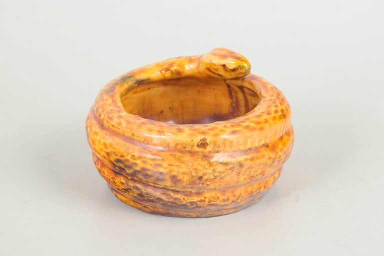 Karl Hansen Reistrup for Kähler, Denmark. Earthenware jar with snake with a sculpted snake: Karl Hansen Reistrup for Kähler, jar with snake. Decorative jar in glazed earthenware featuring a sculpted snake along the rim. Executed in a vivid yellow-orange crackle glaze with rich surface