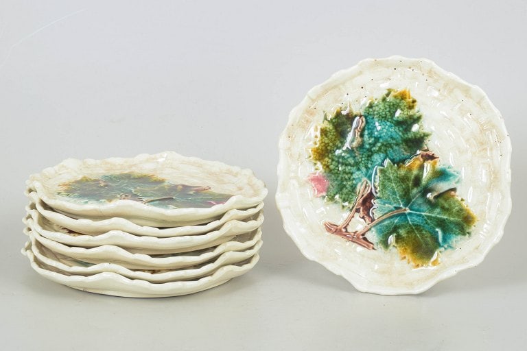 Gustavsberg, Sweden. Majolica set of seven plates with relief moulded and floral decoration . Circa: Gustavsberg majolica set of seven plates. Decorative plates in glazed faience with relief moulded and naturalistic floral decoration in colourful majolica glaze. Hallmark. Origin: Sweden. Material: Fa