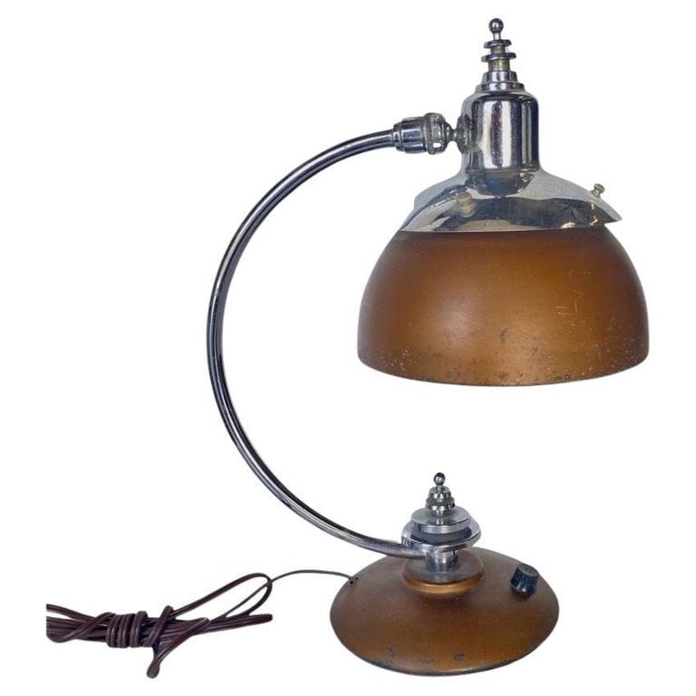 1930's Machine Age Chrome and Copper Desk Lamp: Machine Age, Art Deco Copper, and Chrome Desk Lamp from 1932. The lamp features a modernist bell-shaped copper lamp shade with a matching copper base all brought together with a chrome Streamline Mode