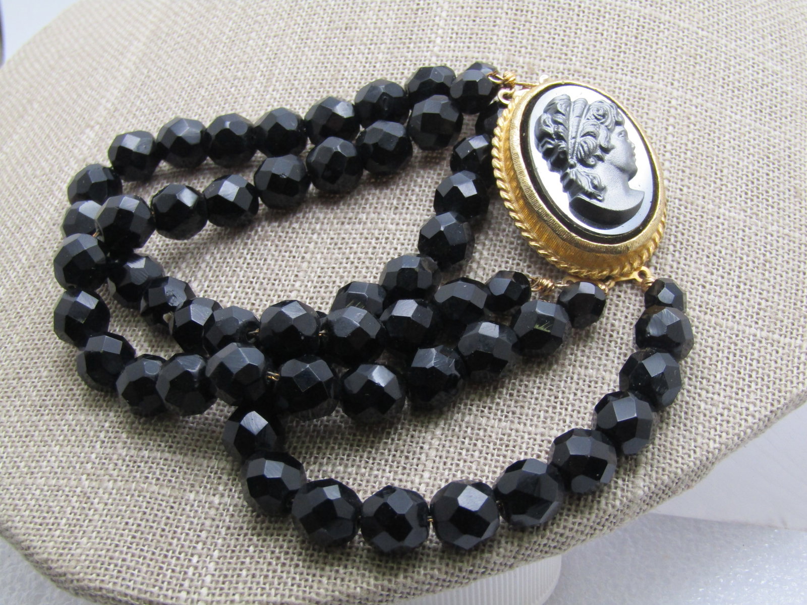 Vintage Black Glass Cameo Bracelet, 8", Triple Strand, 1960's-1970's: Title: Vintage Black Glass Cameo Bracelet, 8", Triple Strand, 1960's-1970's Description: Vintage Black Glass Cameo Bracelet, 8", Triple Strand, 1960's-1970's. 8mm round faceted black glass beads with 