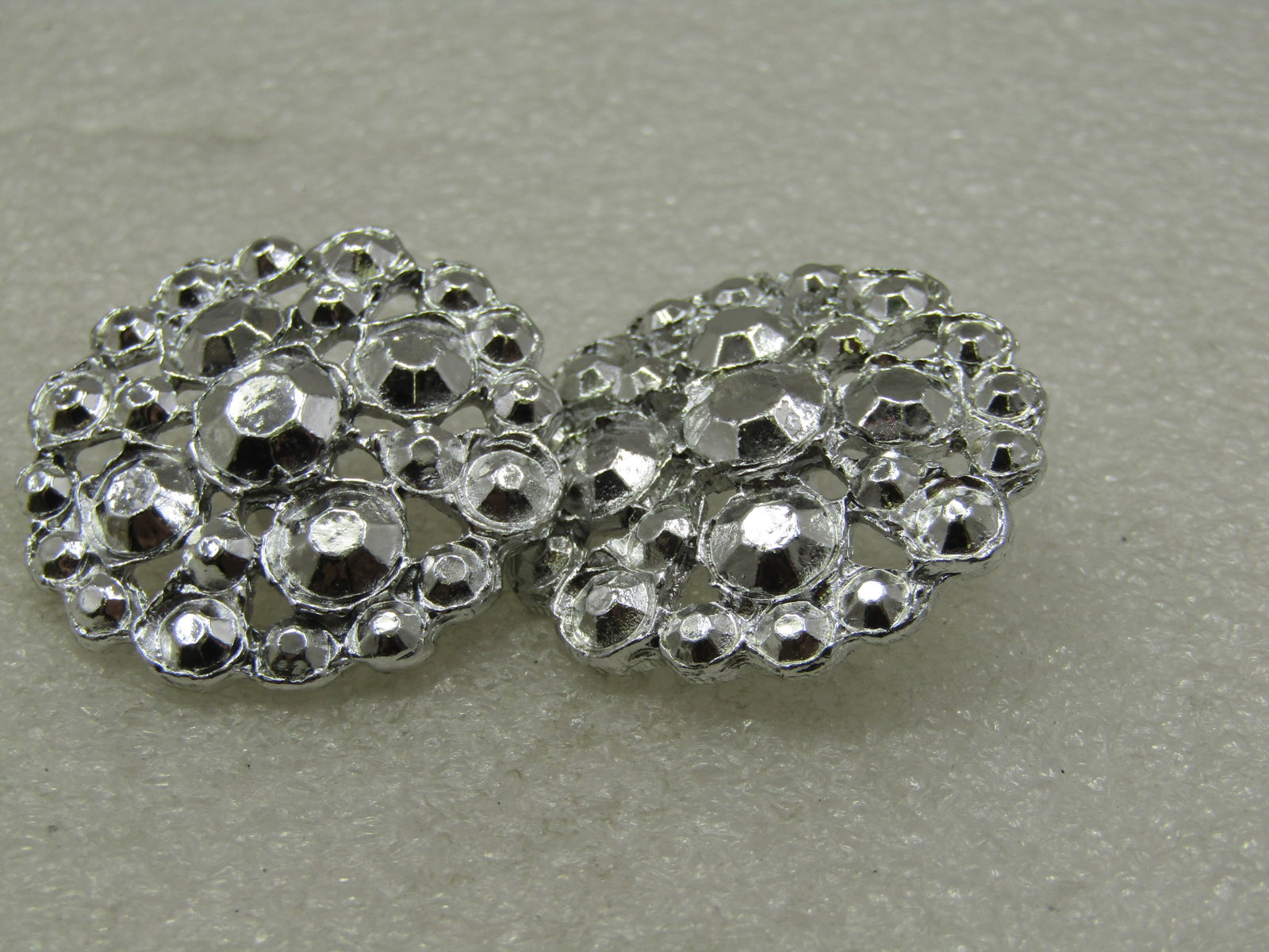 Vintage Pair Metal Buttons, Silver Tone, 1-3/8": Title: Vintage Pair Metal Buttons, Silver Tone, 1-3/8" Description: Vintage Pair Metal Buttons, Silver Tone, 1-3/8". The buttons have the look of rhinestoens but they are all metal with a molded