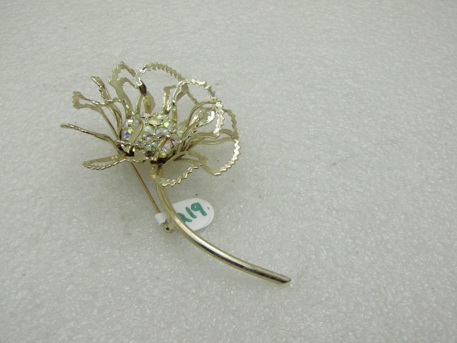 Vintage Sarah Coventry Illusion Floral Brooch: Title: Vintage Sarah Coventry Illusion Floral Brooch Description: Vintage Sarah Coventry Floral Brooch - over 3.5" tall and 2.25" wide with aurora borealis rhinestone center that is set deep in the