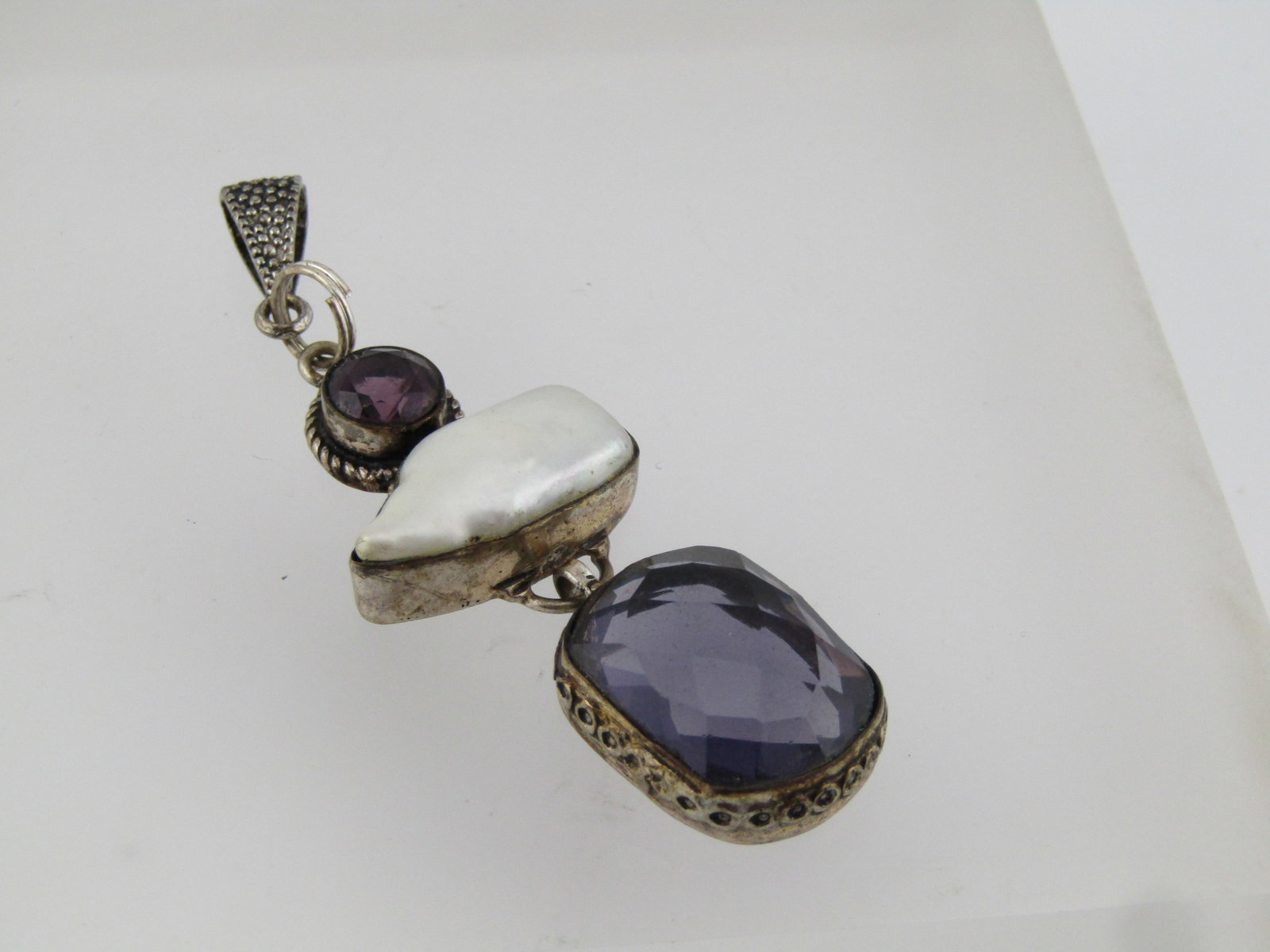 Silver Plated Pearl, Purple Glass Drop Pendant, 1980's-1990's: Title: Silver Plated Pearl, Purple Glass Drop Pendant, 1980's-1990's Description: Silver Plated Pearl, Purple Glass Drop Pendant, 1980's-1990's. It has a textured silver tone bail and settings around 