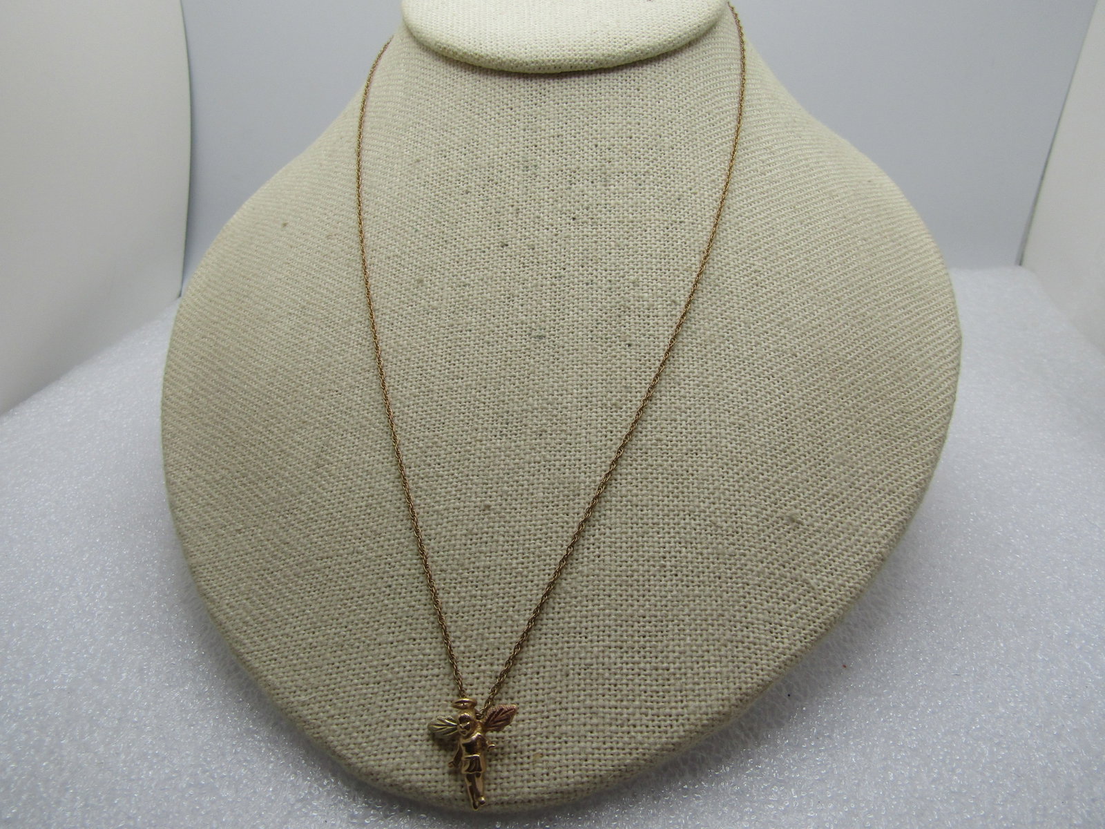 Vintage 10kt Gold Angel Pendant on 14kt G.F. Chain, 18", 1980's: Title: Vintage 10kt Gold Angel Pendant on 14kt G.F. Chain, 18", 1980's Description: Vintage 10kt Gold Angel Pendant on 14kt G.F. Chain, 18", 1980's. The angel is marked 10kt and has the look of Black 
