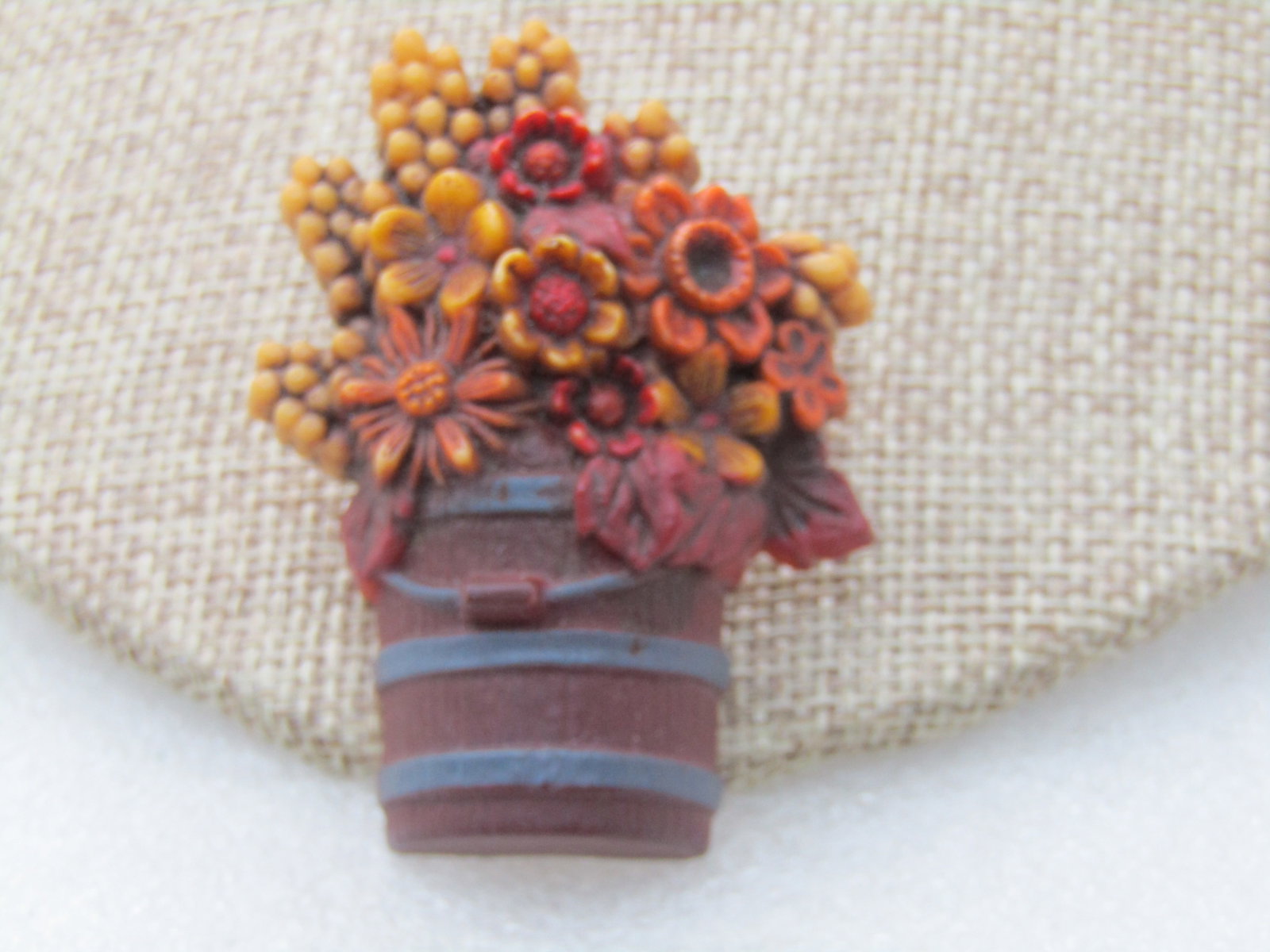 Vintage Hallmark Fall Bucket of Flowers Brooch, 2.25": Title: Vintage Hallmark Fall Bucket of Flowers Brooch, 2.25" Description: Vintage Hallmark Fall Bucket of Flowers Brooch, 2.25" by 1.5". Brown and gray bucket with tan and orange, and red flowers.