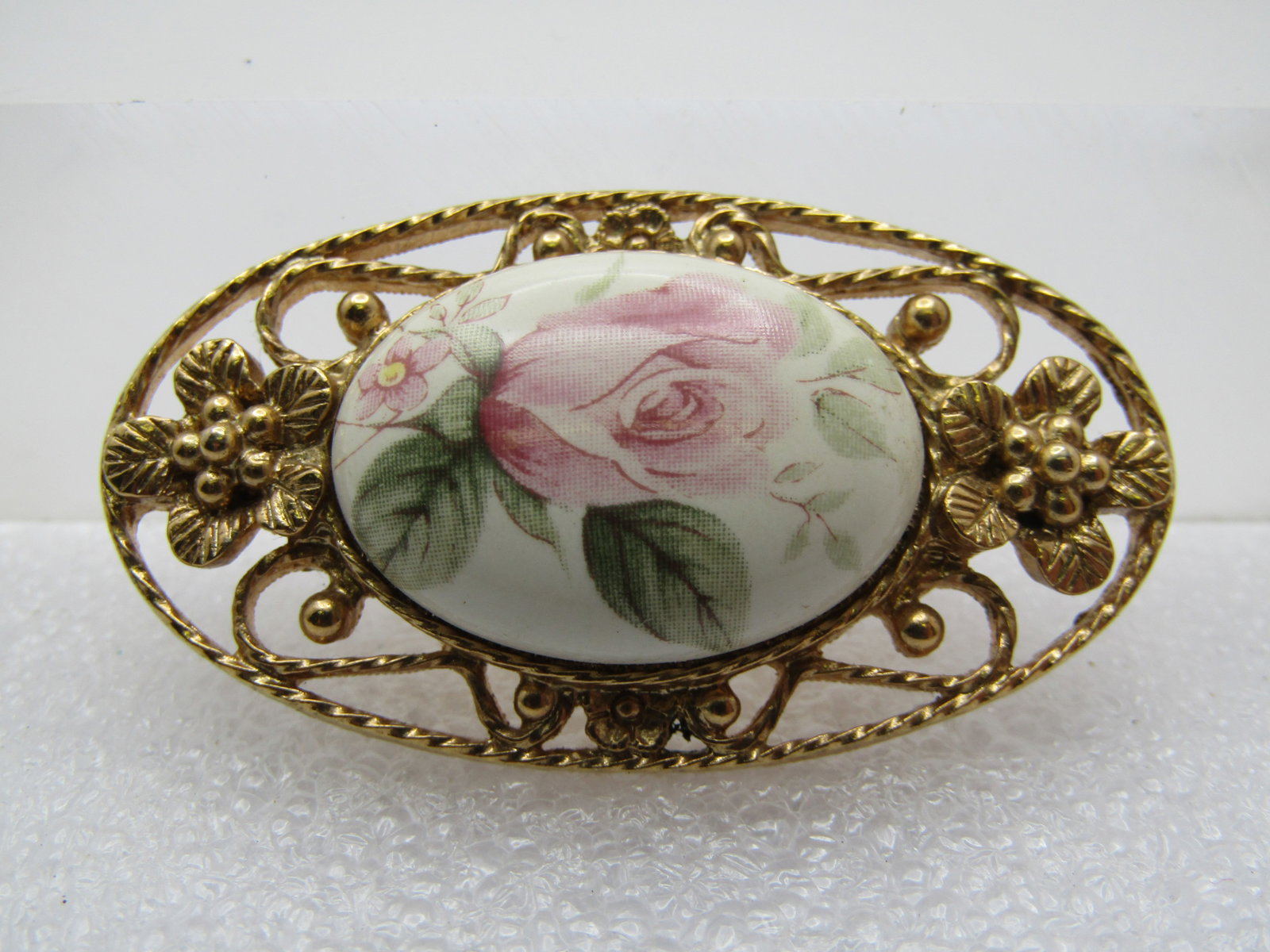 Vintage Ceramic/Porcelain Rose Brooch, 1960's-1970's, 1-7/8": Title: Vintage Ceramic/Porcelain Rose Brooch, 1960's-1970's, 1-7/8" Description: Vintage Ceramic/Porcelain Rose Brooch, 1960's-1970's, 1-7/8" wide and 1-1/8" tall. It has a pink rose bud with green le